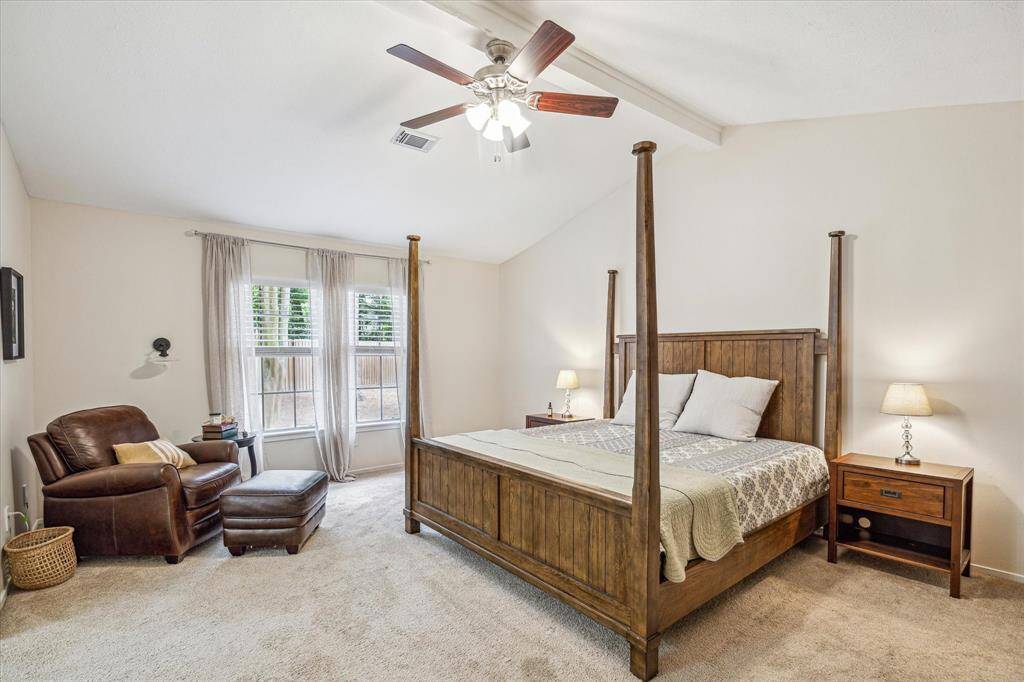 The vaulted ceilings carry into the primary suite, creating an airy and spacious atmosphere to unwind in.