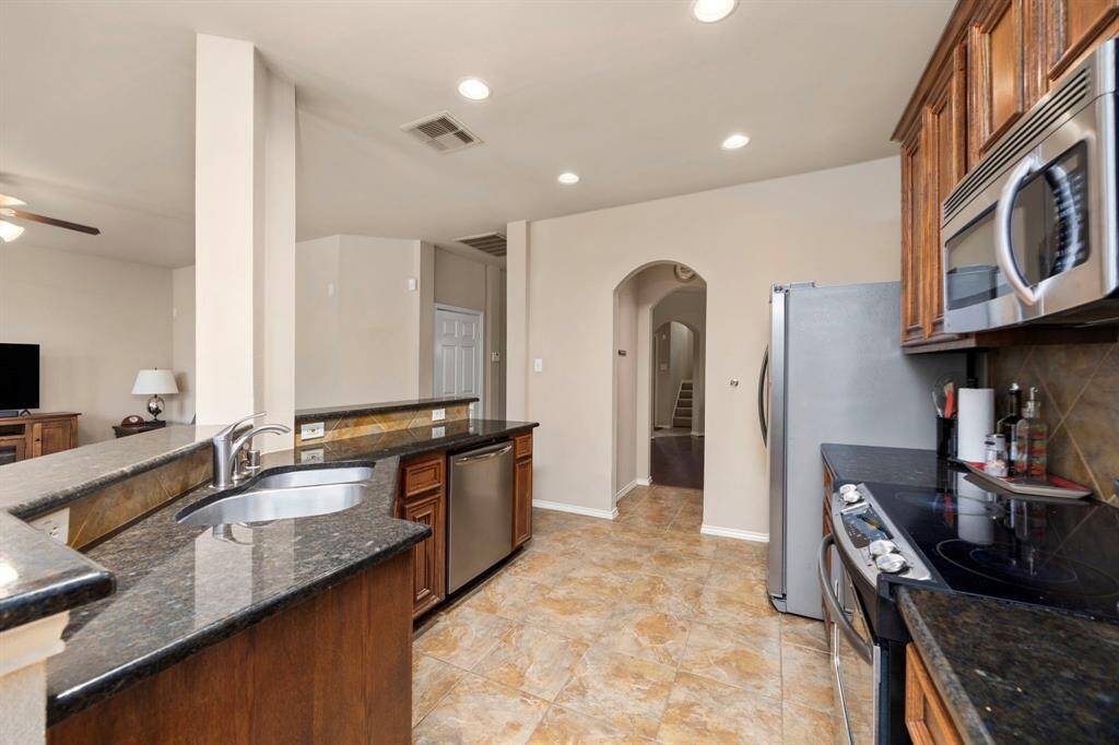The kitchen features stainless steel appliances and has ample space for all your cooking needs!