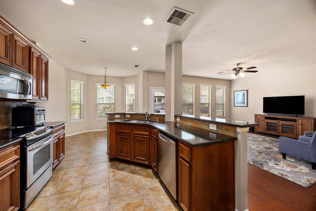 You'll have a perfect view of the living and breakfast room from the kitchen!