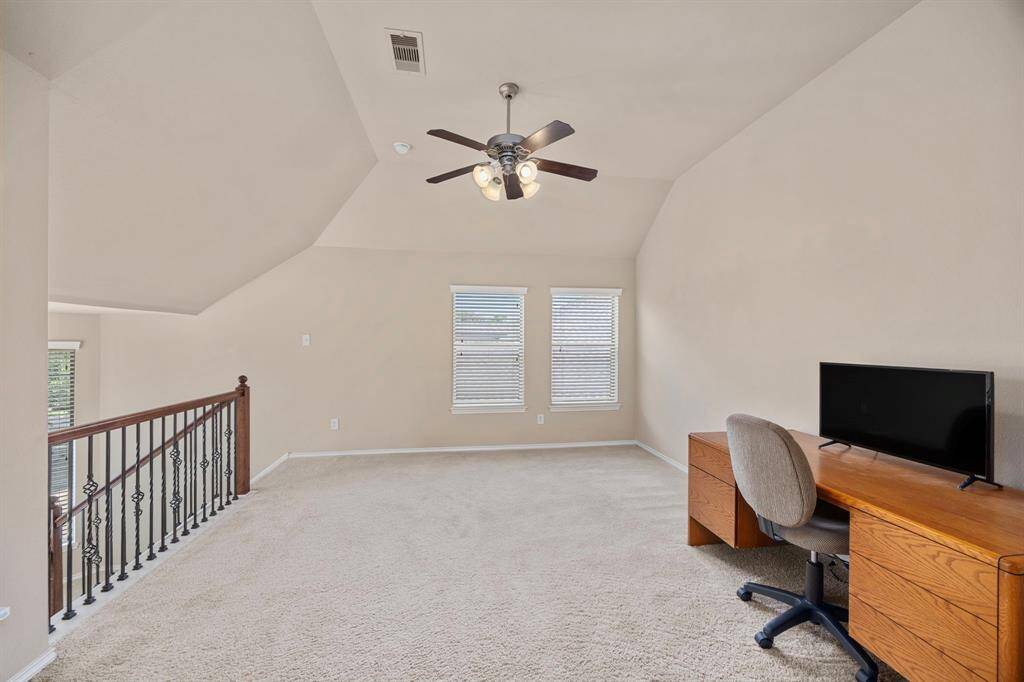The loft also features a ceiling fan along with three windows allowing for more natural light to enter the home.