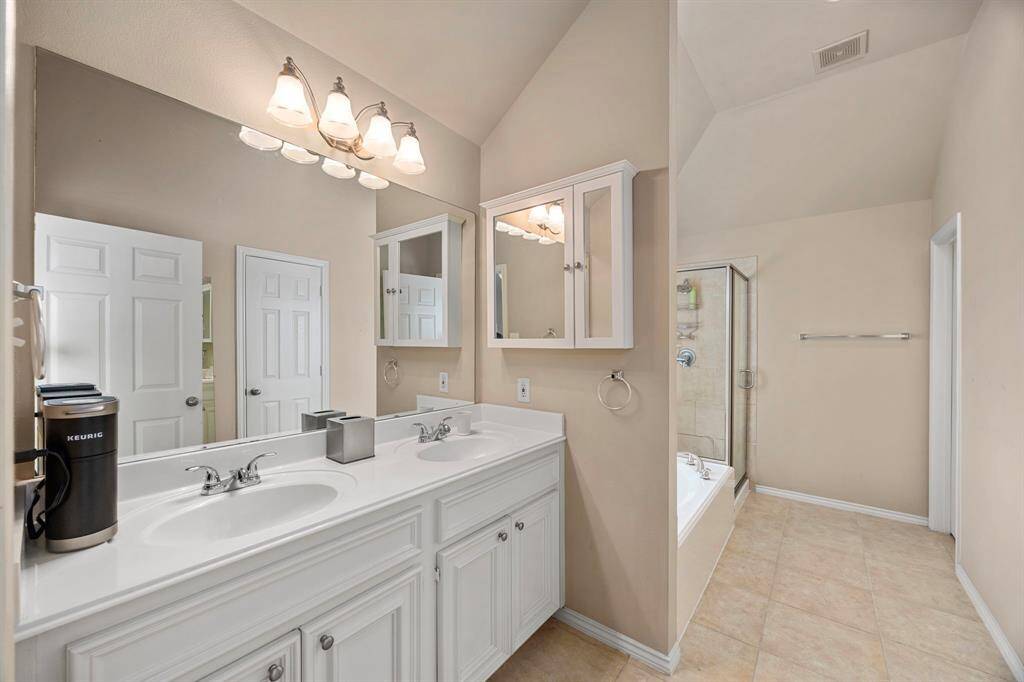 The primary bath features a double vanity and a walk in closet.