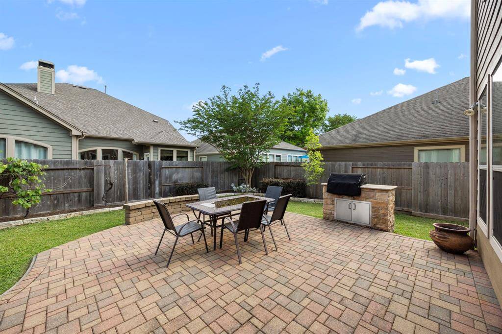 As you exit into the backyard you'll be stepping onto a gorgeous paver to a backyard featuring a grill with a natural gas line.