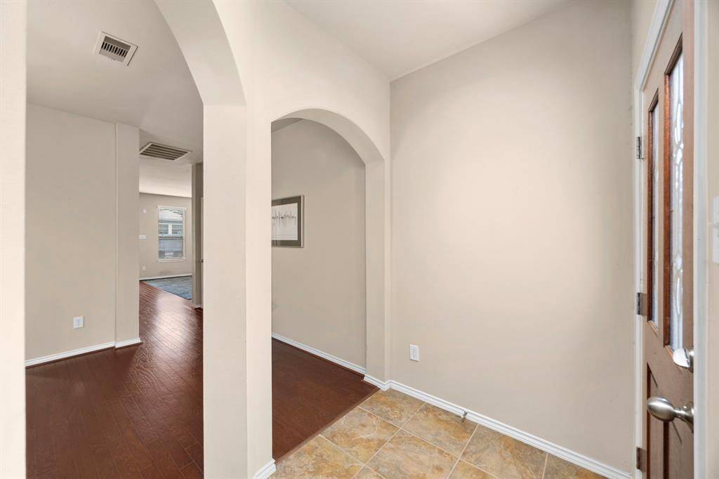You'll enter the home and be lead onto the hardwood flooring as you head into the formal dining area.
