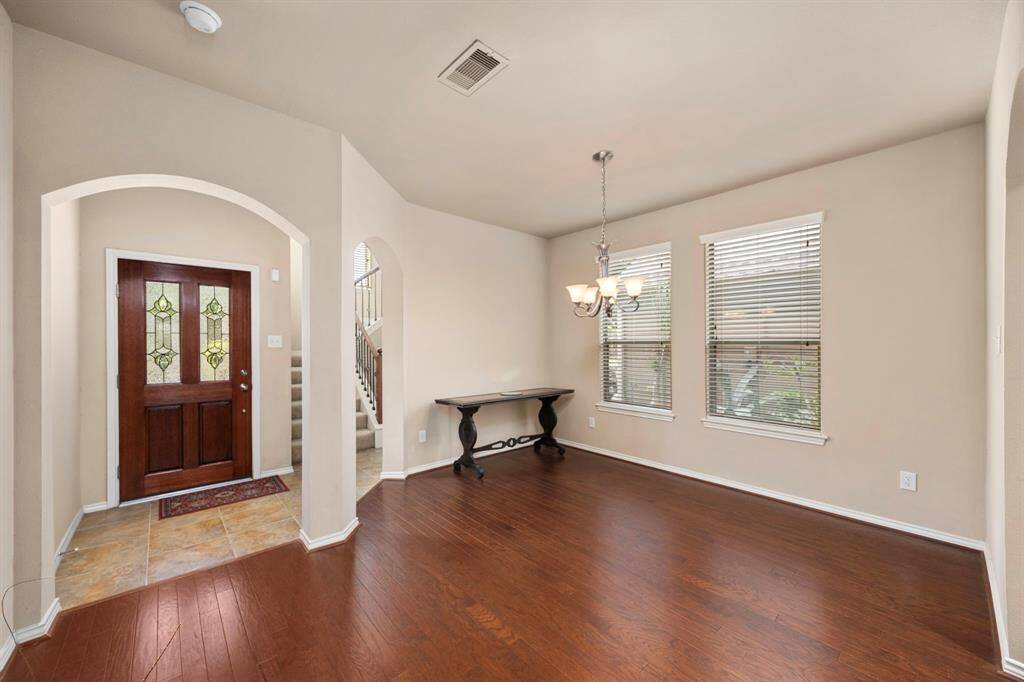 The formal dining features a hanging light fixture for optimal lighting.