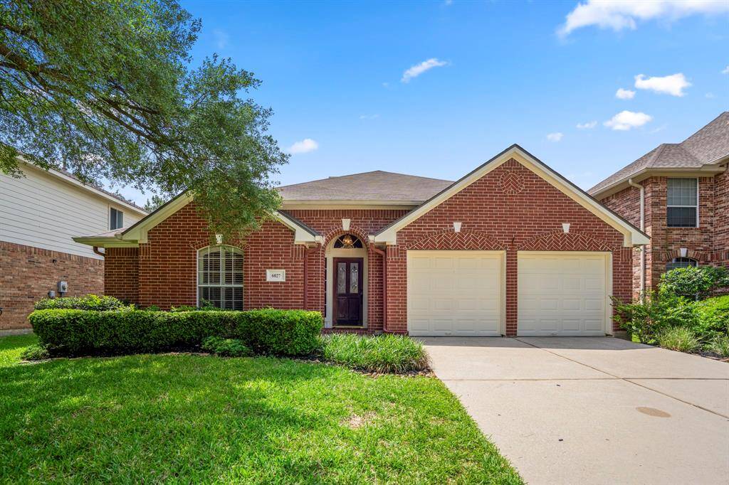Welcome to 6027 Sawyer Bend—nestled in the golf course community of Windrose, this red brick beauty features timeless curb appeal with mature trees and classic arch details.