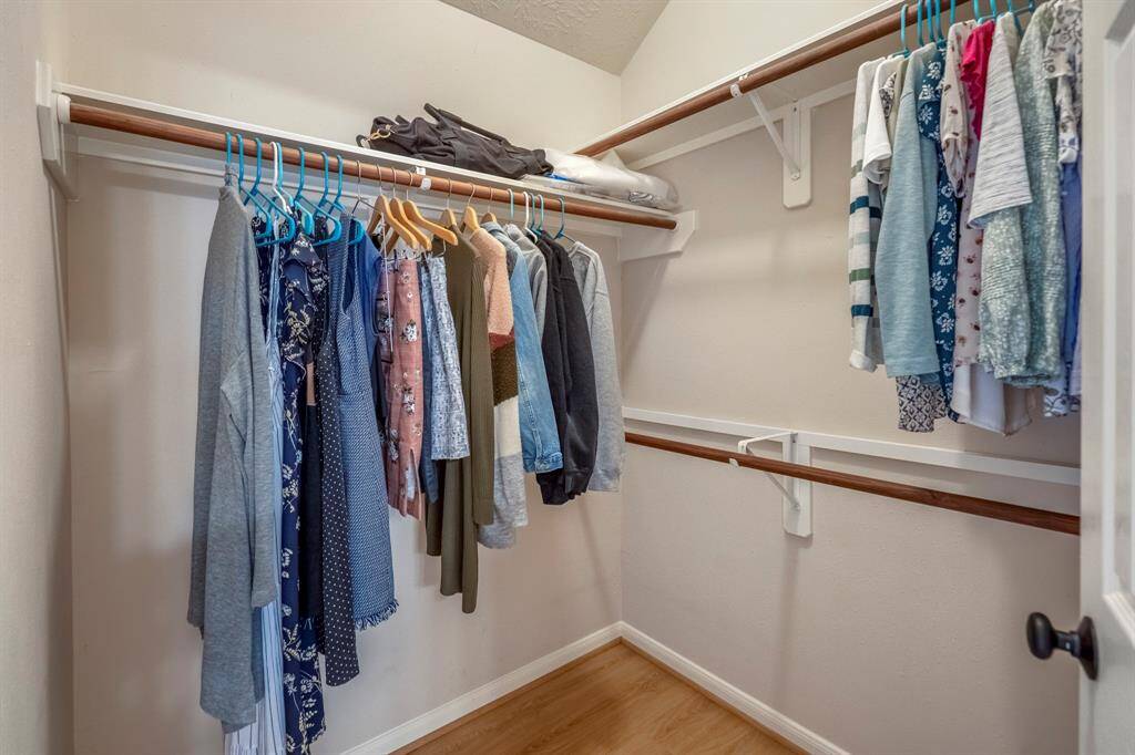 A peek inside one of the two walk-in closets reveals plenty of hanging space, offering ample room for all your belongings and keeping everything organized.