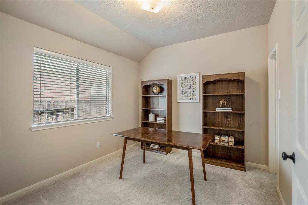 This secondary bedroom offers a cozy retreat with brand new carpet and a convenient walk-in closet, providing ample storage for all your needs.