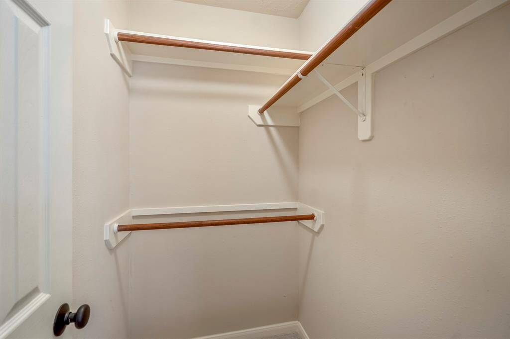 A view inside the walk-in closet reveals plenty of hanging space and thoughtful organization, making it easy to keep your wardrobe neat and accessible.