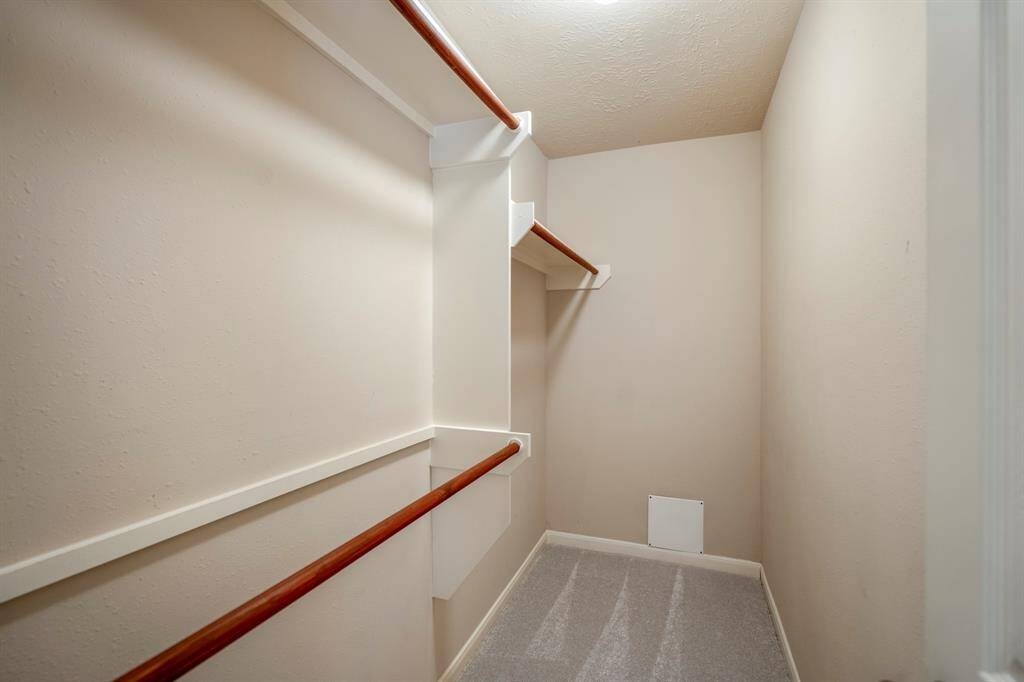 A view inside the walk-in closet reveals plenty of hanging space, offering generous room to organize and store your wardrobe with ease.