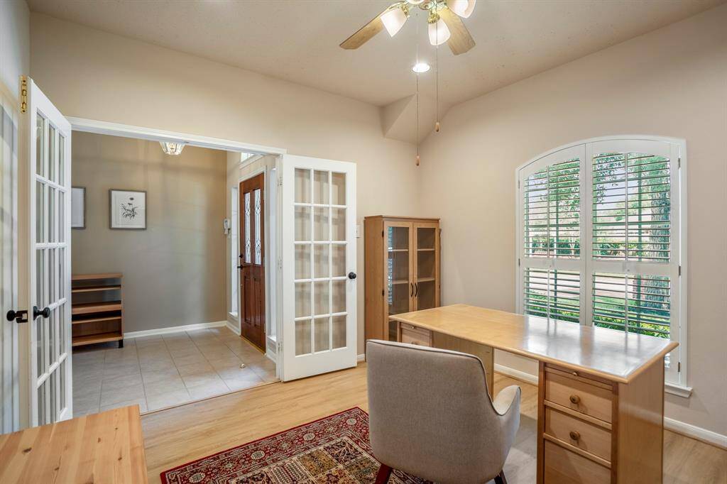 Looking back at the foyer from inside the study, the glass French doors offer a beautiful view of the entryway, adding an open, inviting feel to the space.