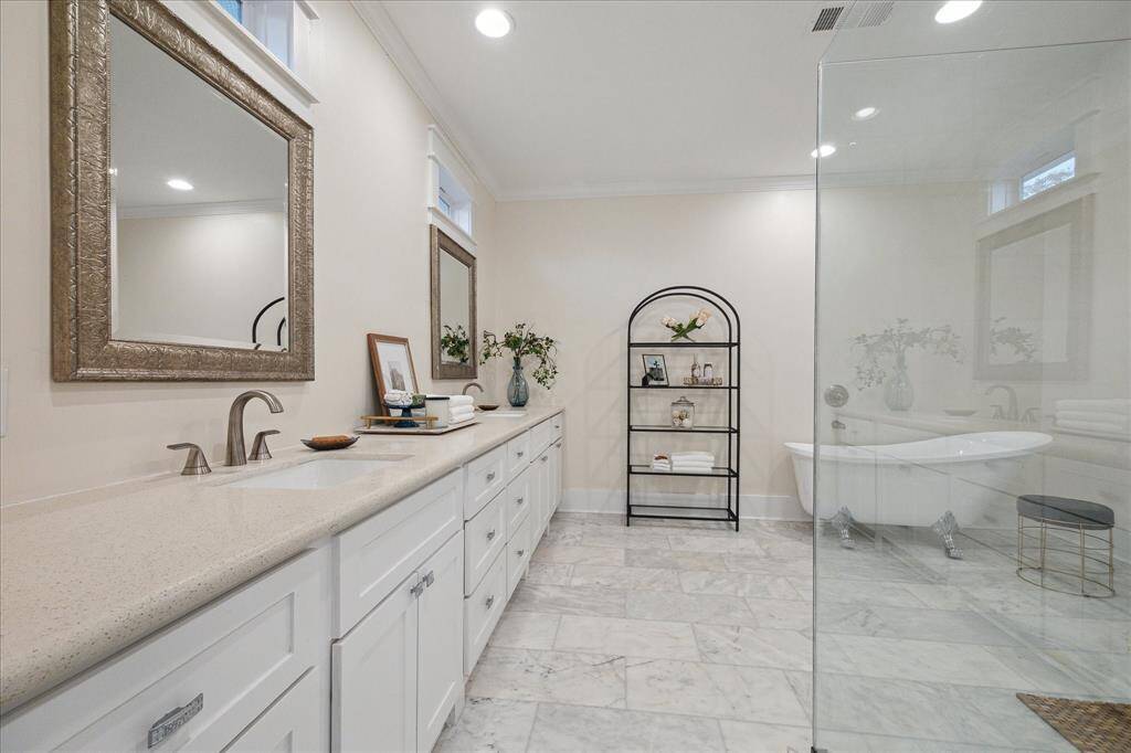 Large primary bathroom with walk-in shower and charming crawfoot tub!