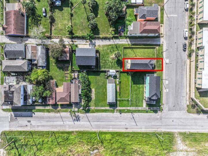 An aerial view of the home highlights the great location of this home. The lot beside the home (included in the fenced area) is also for sale separately.