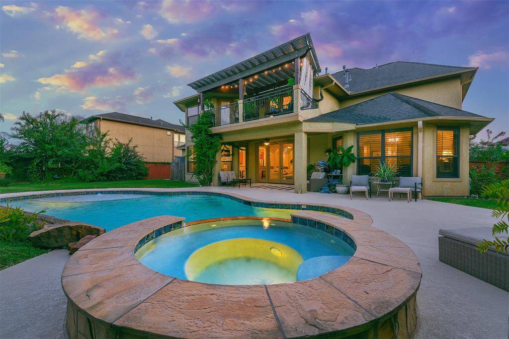 Gorgeous custom home with large back yard, covered patio, balcony patio, side yard garden, saltwater pool with stone coping surround.