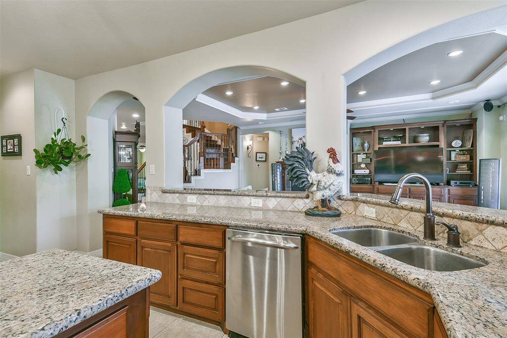 Open archways to the living area. Bar height counter tops for additional bar seating all around! Deep double sink with oil rubbed bronze faucet. Travertine backsplash.