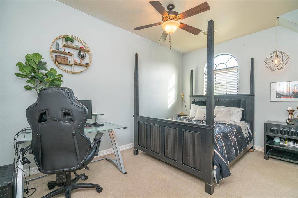 The second of 6 upstairs bedrooms. This room has a large walk in closet space, 2 inch blinds with a window that faces the front of the home. Lighted ceiling fan and room for a large bed!