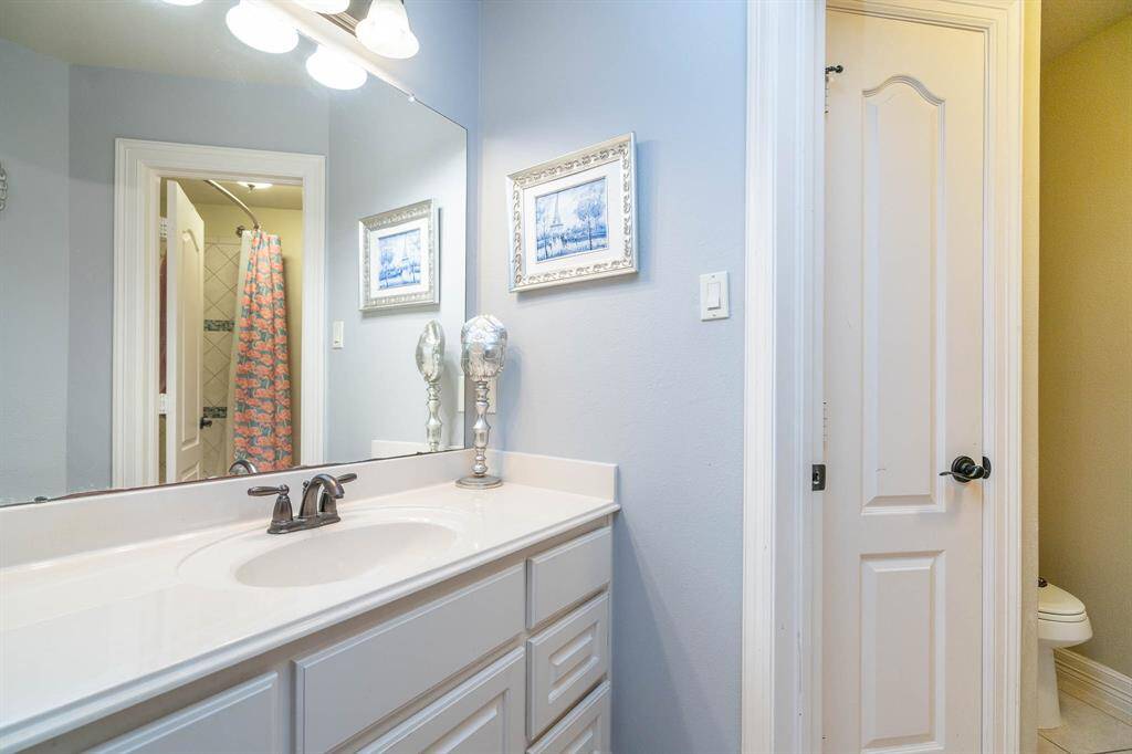 Bathroom attached to optional master suite with tub/shower combo and glass accent tiles. Large vanity for plenty of storage space as well as additional linen closet. Oil rubbed bronze light fixtures and faucets match the lever handles throughout.