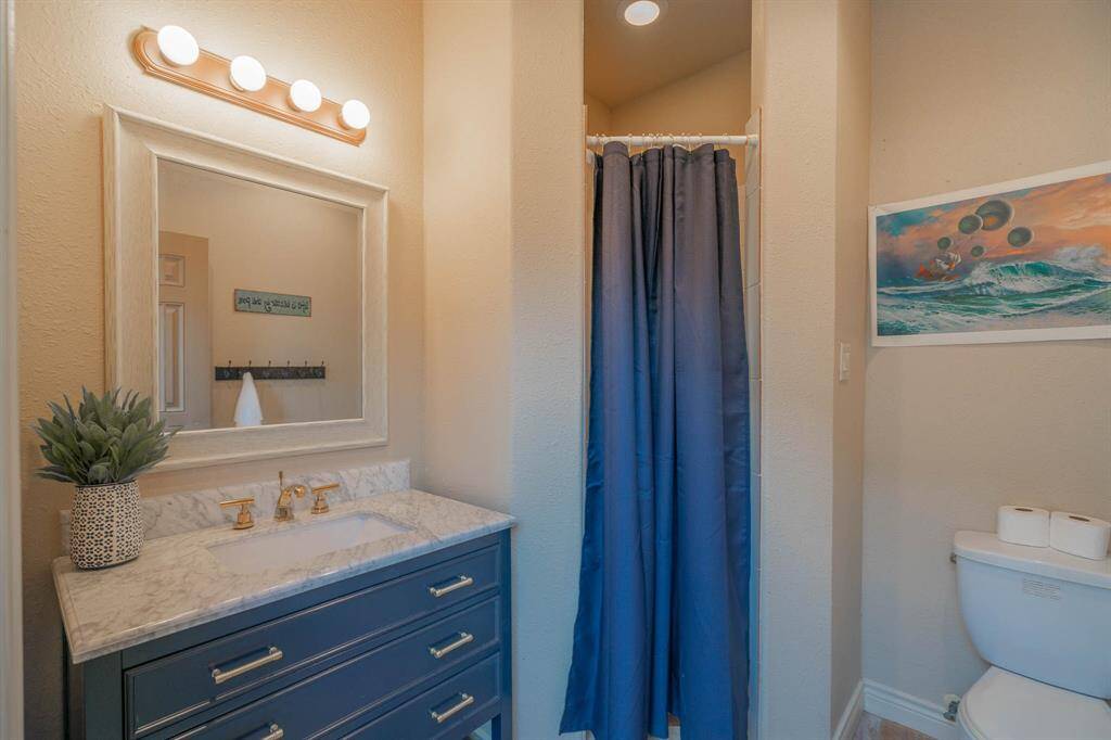 5th full size bathroom in the home is located by the pool area. Large vanity with marble top. Flooring is a beautiful slate (not slippery when wet).Full size walk in shower with tile surround. Recessed lighting.