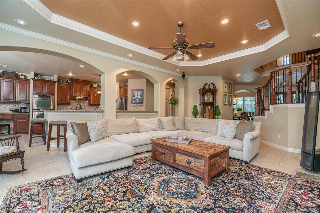OPEN CONCEPT! The heart of the home for living and entertaining! Large living area open to the kitchen with recessed lighting, ceiling fan, built in surround sound. Plenty of beautiful accents can be found throughout the home like the archways, art niches, and built in shelving.