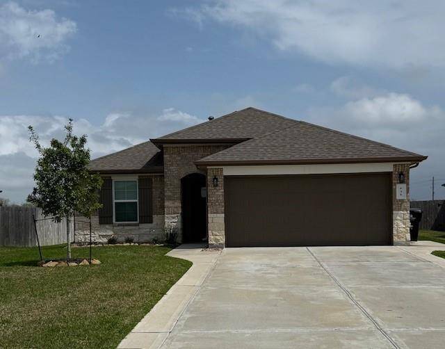Front of home with widened driveway