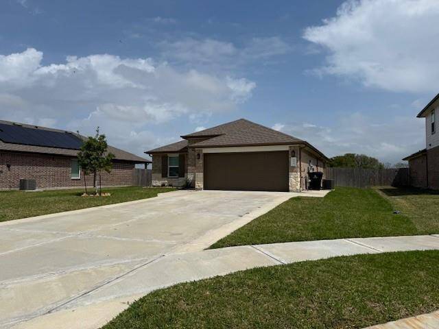 Extended driveway with concrete pad on side of home to store your garbage bin