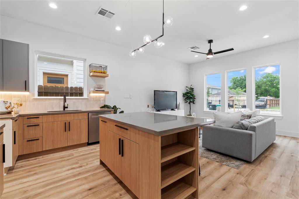 Whether you're preparing a meal for guests or unwinding in the bright and airy living space, this modern and functional open-concept design ensures comfort and style at every turn.