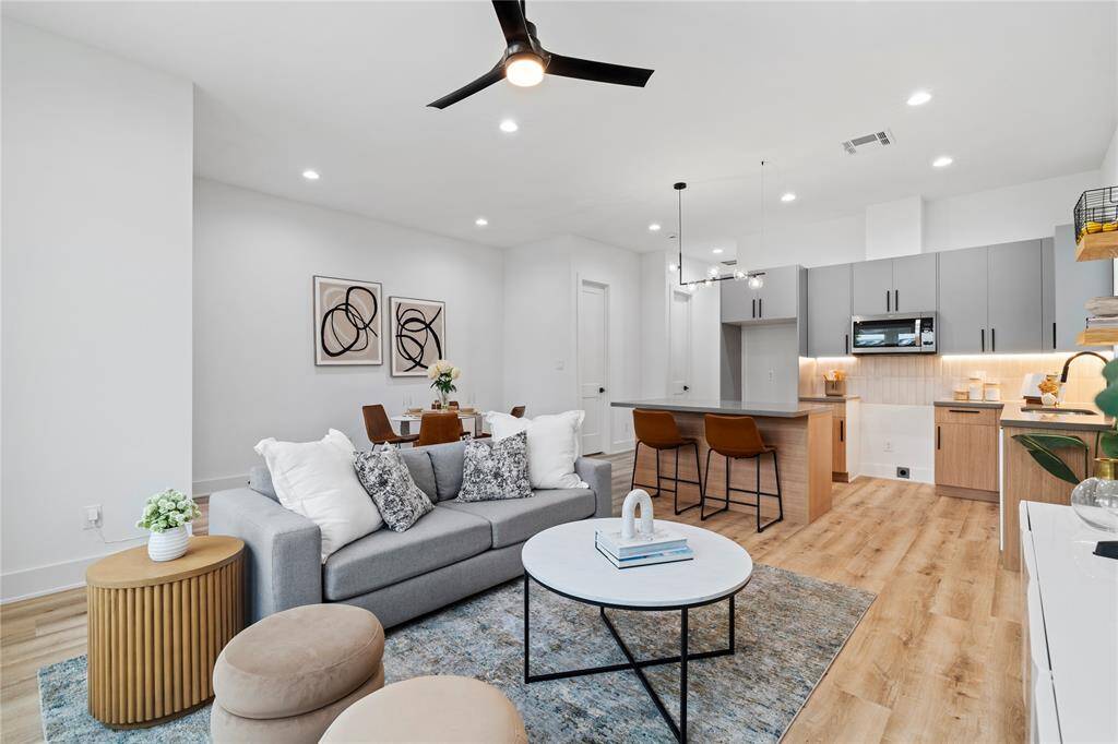 Designed for both style and functionality, this open-concept space seamlessly connects the kitchen, dining, and living areas, creating the perfect environment for entertaining and everyday comfort.