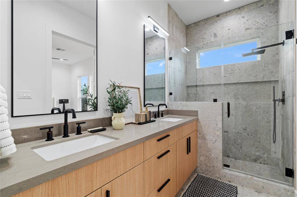 Step into your primary bathroom, a serene retreat designed for ultimate relaxation and tranquility after a long day.