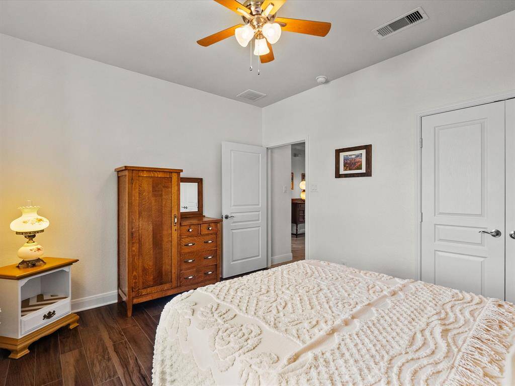 Double closet doors offer plenty of storage pace in the secondary bedroom.