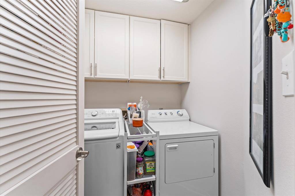 Laundry room with cabinets.