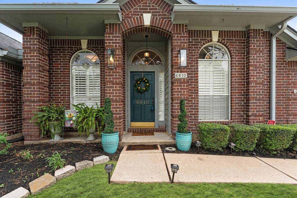 All brick, gutters all around and beautiful glass and iron sconce lights.