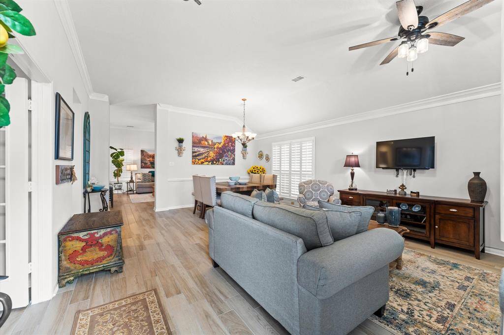 As you walk in the house, notice the beautiful tile floors, crown molding and plantation shuttlers!