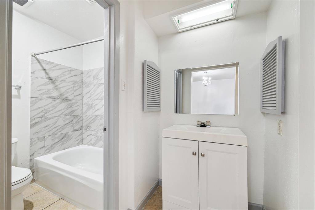 Fully renovated bathroom connects to the principal bedroom