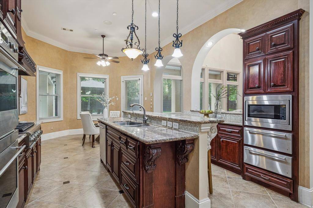 Expansive sightlines and soaring archways set the tone for upscale living, complemented by tailored cabinetry and refined finishes throughout.