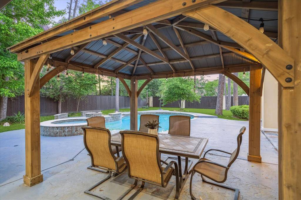 Dine al fresco under the rustic wood-beam pavilion, perfectly positioned to enjoy poolside views and cool evening breezes.