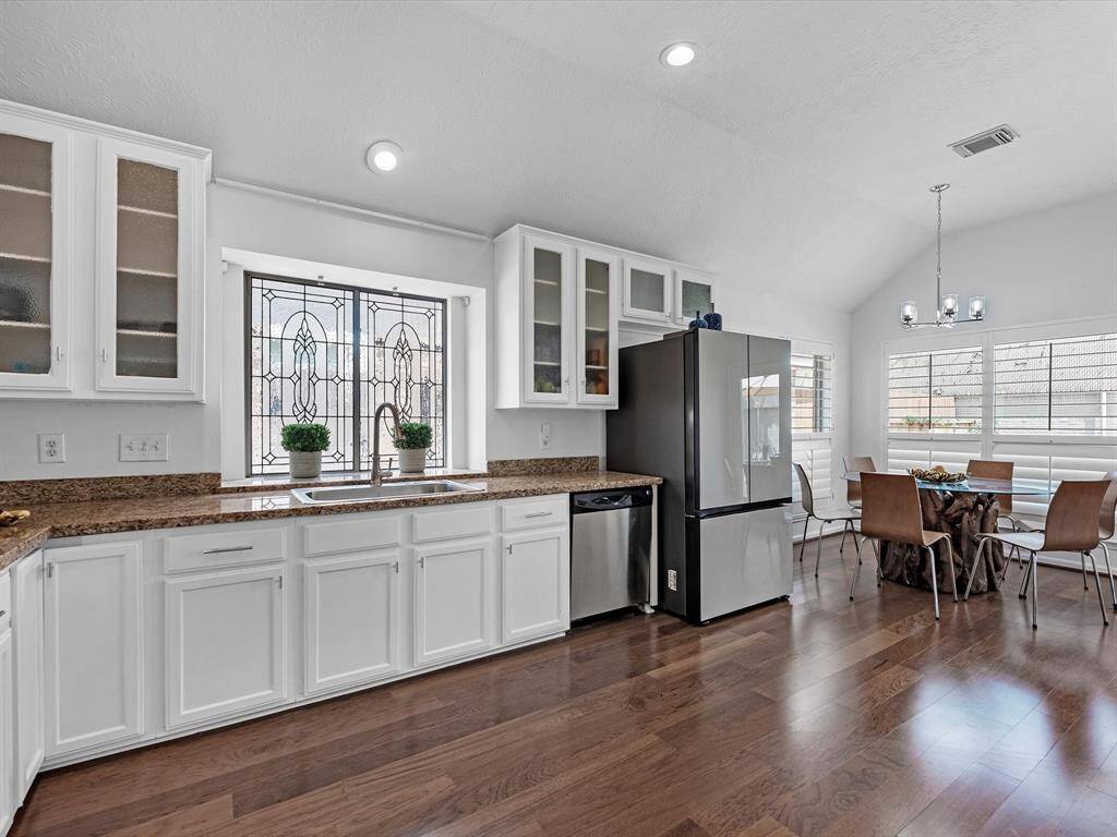 This Kitchen view highlights the beveled glass windows over the sink.