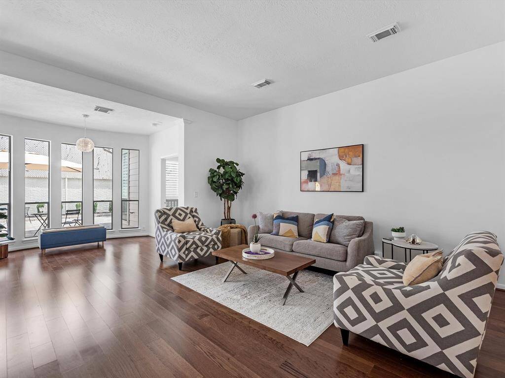 Your Living Room features laminate wood flooring and a Sitting Nook along the back windows.