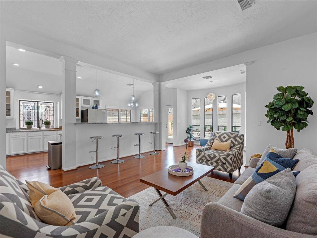 Another View of the Living Room with the Breakfast Bar and Kitchen in the background.