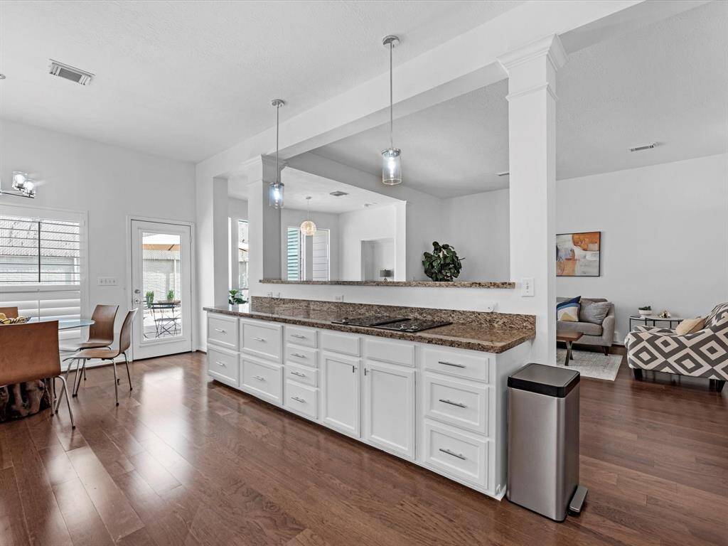 The expansive Kitchen has granite counter tops and is open to the Living Room & Dining Room.