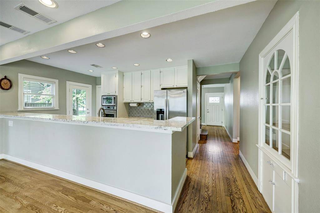 A beautiful built in shelf for displaying treasures and art brings the front room, kitchen, and dining room together perfectly.