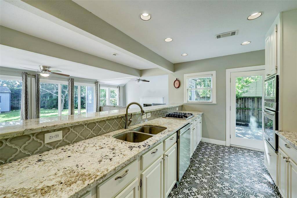 Granite, hand selected countertops and beautiful tile flooring makes this kitchen a dream.