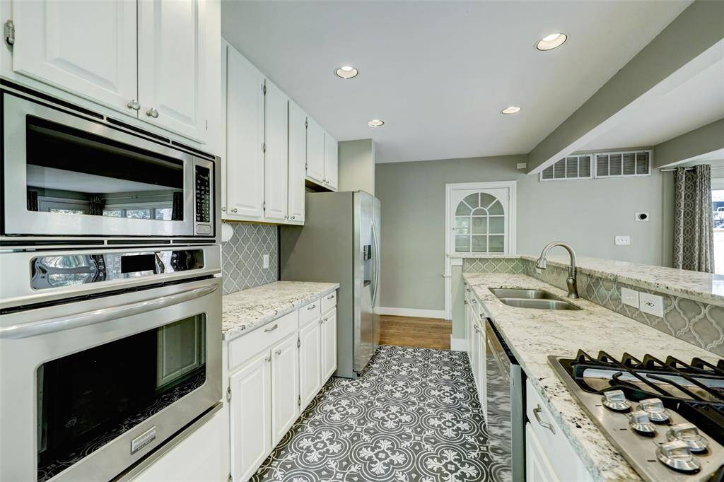 Stainless steel appliances and a conveniently situated range make culinary endeavors fun and enjoyable.