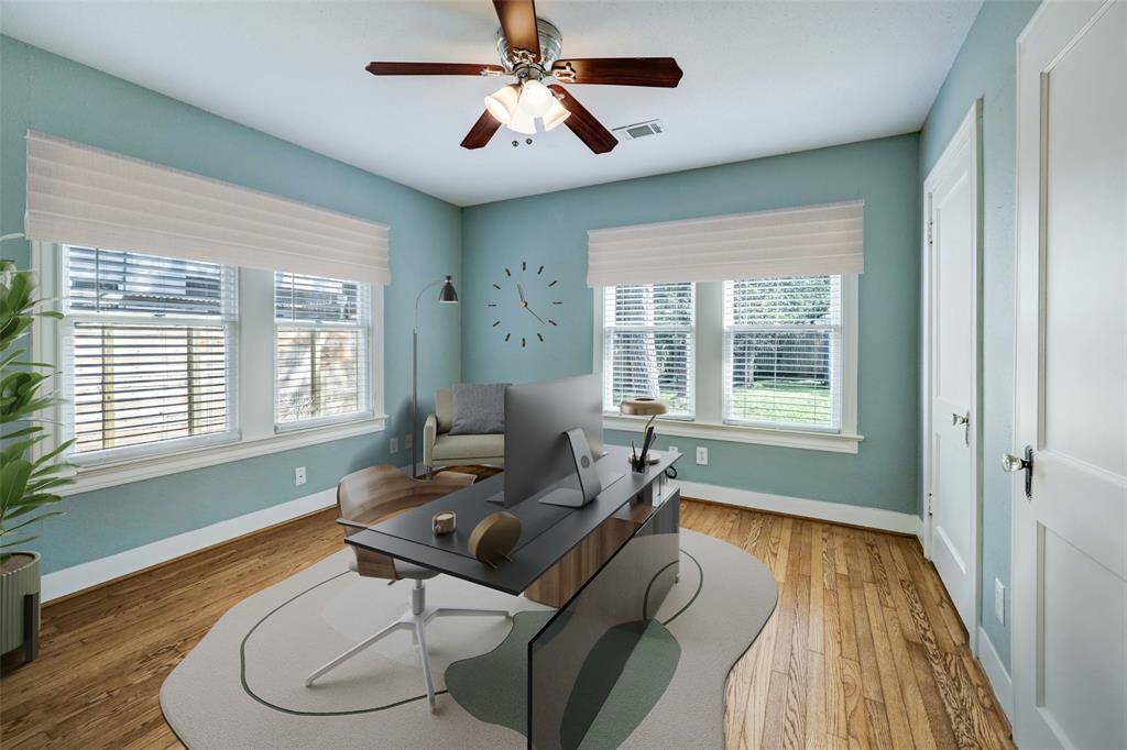 This secondary bedroom faces the back lawn, providing elegant lighting and a gorgeous view.