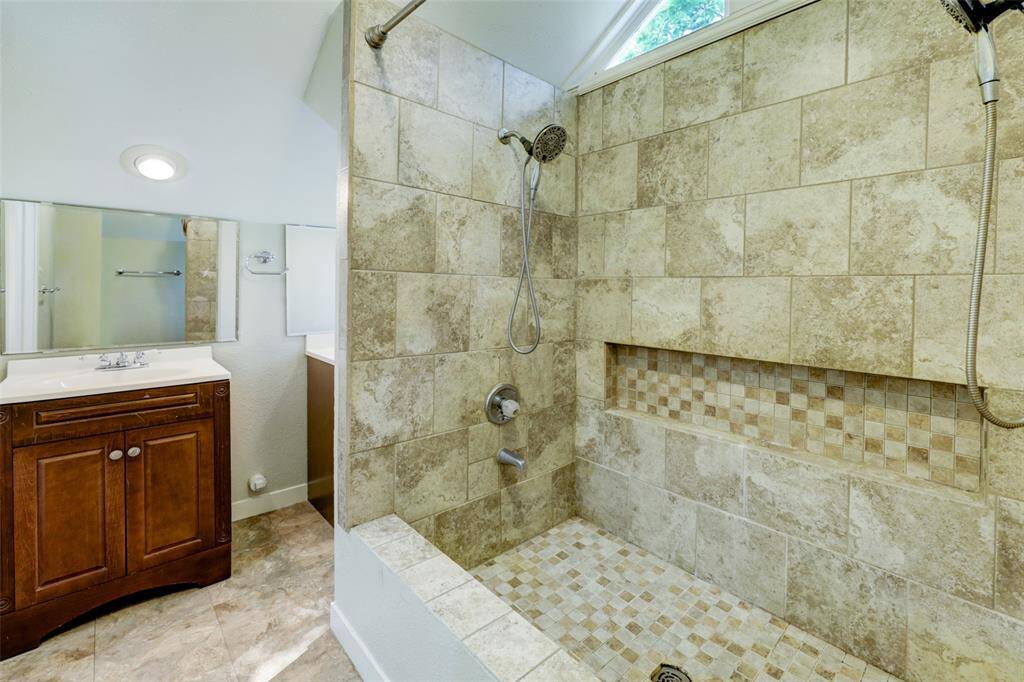 Double shower heads offer luxury in the primary's en-suite bath.