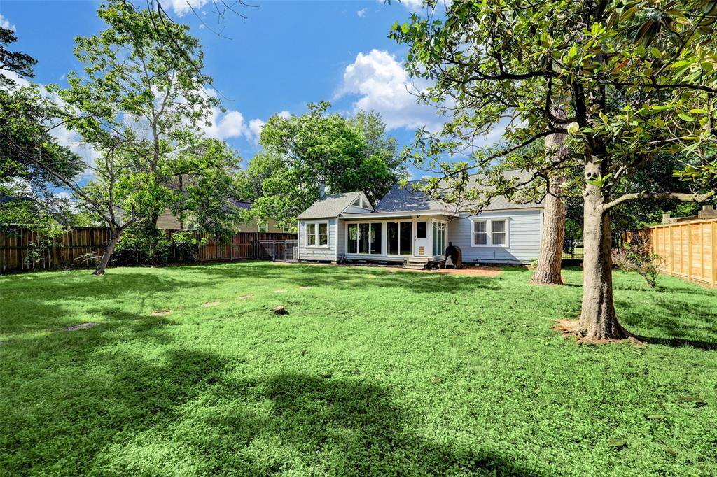 The sprawling back lawn boasts possibilities for outdoor enjoyment.