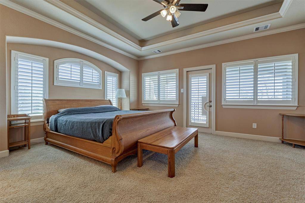 The primary bedroom has stunning lake views and features a covered balcony.