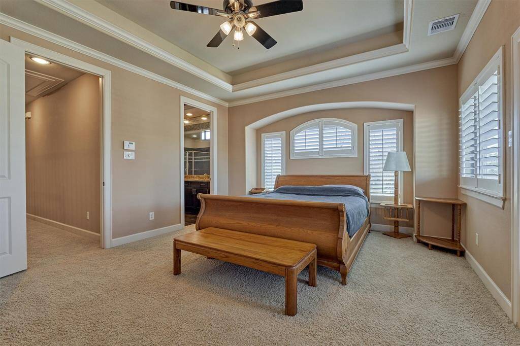 Crown molding and custom shutters add the perfect finishing touches to this room.