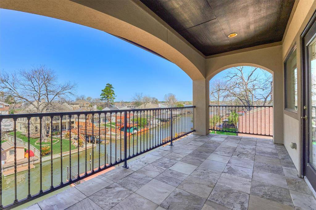 The view of the lake from the third floor balcony off of the primary bedroom. Imagine enjoying your coffee here in the morning or winding down after a long day.