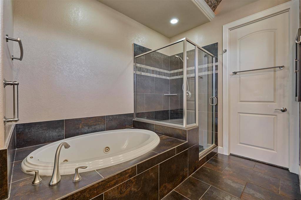 The bathroom also features a jetted tub, separate shower and large closet.