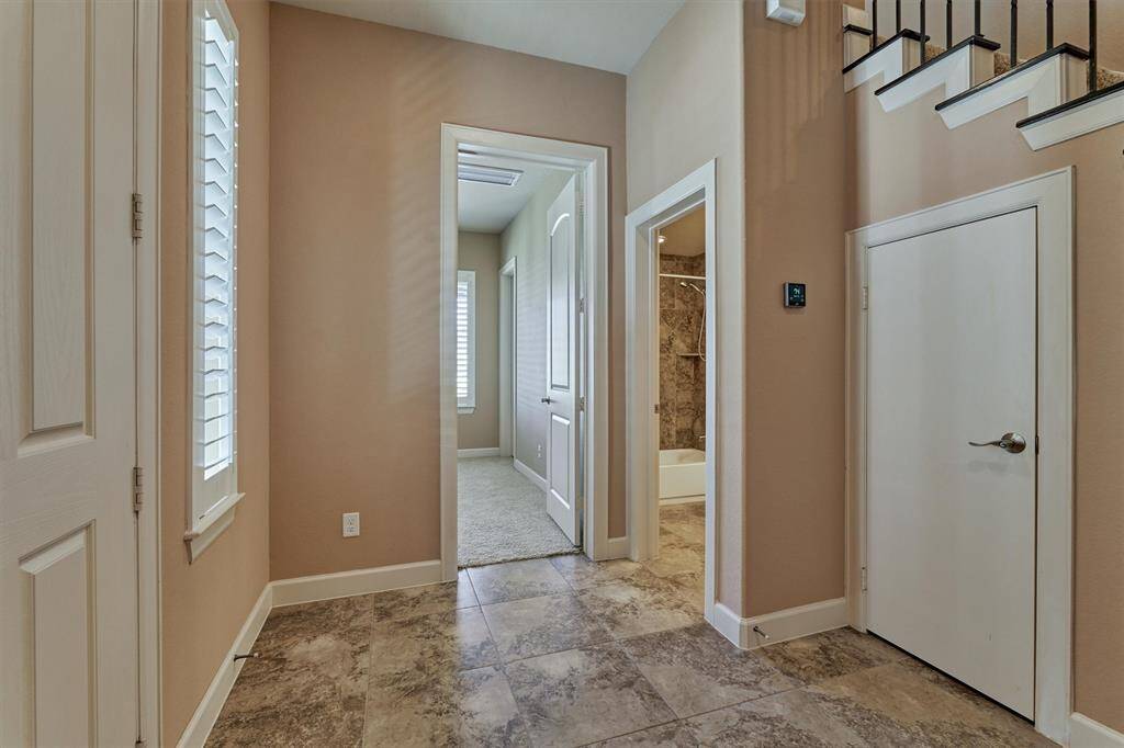 A bedroom with walk in closet and full bath are on the left of the entry on the first level.