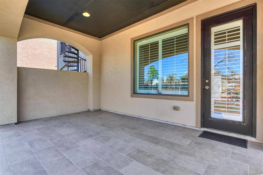 Back porch on the first floor with tile flooring.